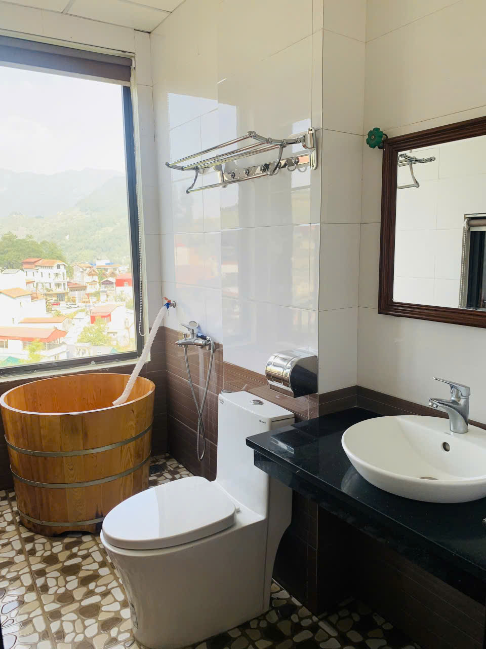 Bathroom with wooden tub and mountain view