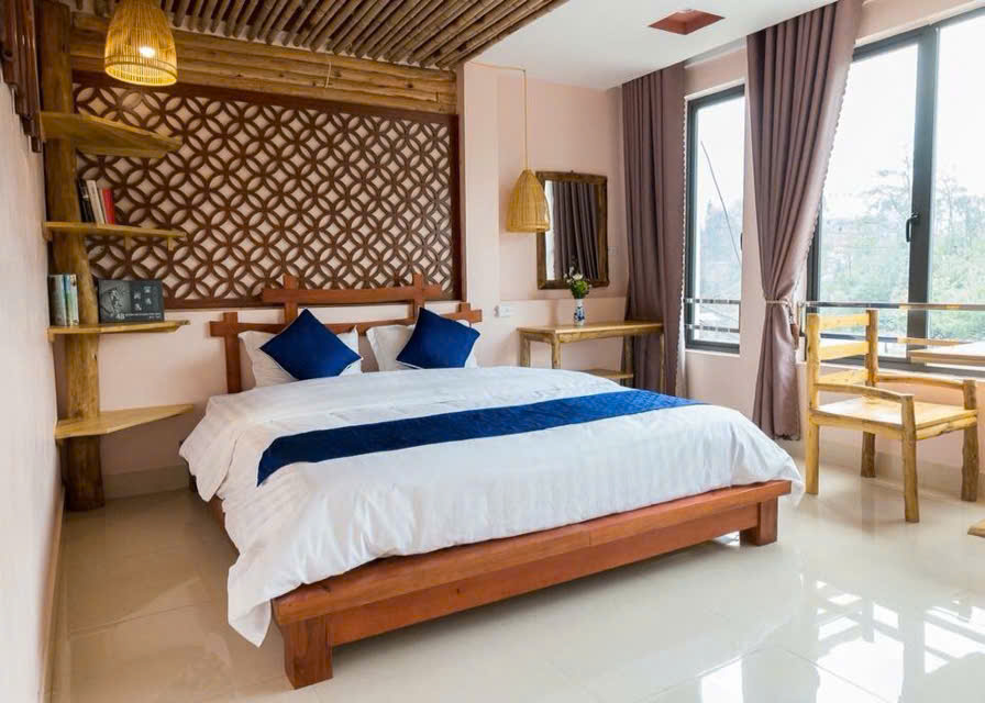 Room with indigo-striped bed runner at Sapa Indigo Inn
